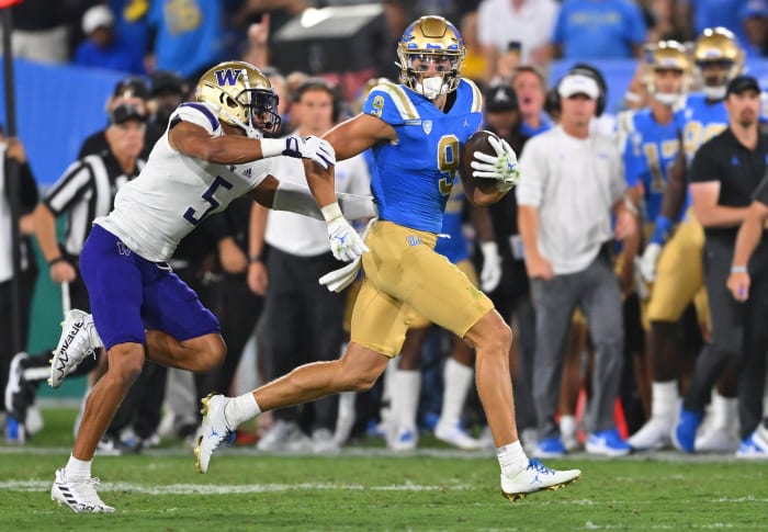 Sep 30, 2022; Pasadena, California, USA; UCLA Bruins wide receiver Jake Bobo (9) runs down the sideline for a first down after a complete pass in the first half before he is stopped by Washington Huskies safety Alex Cook (5) in the first half at the Rose Bowl.