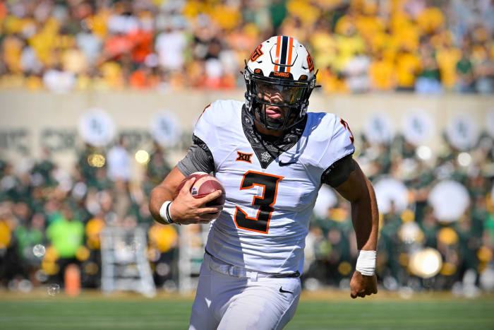 Oct 1, 2022; Waco, Texas, USA; Oklahoma State Cowboys quarterback Spencer Sanders (3) runs for a first down against the Baylor Bears during the first quarter at McLane Stadium.