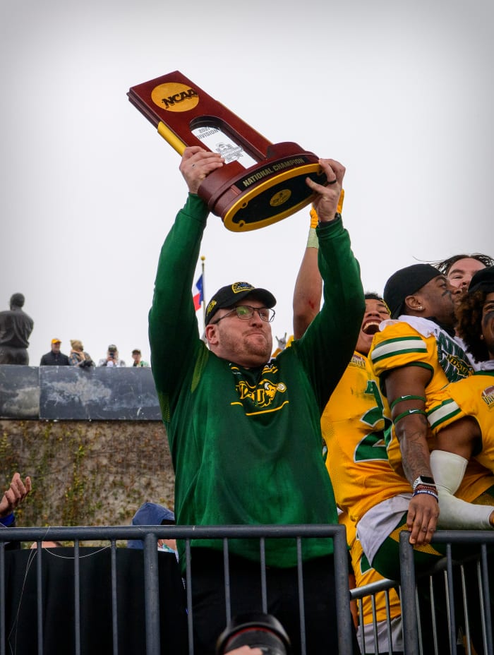 Jan 8, 2022; Frisco, TX, USA; North Dakota State Bison head coach Matt Entz holds up the championship trophy as the North Dakota State Bison team celebrates the win over the Montana State Bobcats in the FCS Championship at Toyota Stadium.