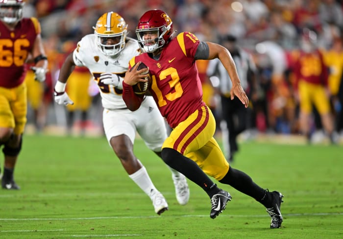 Oct 1, 2022; Los Angeles, California, USA; USC Trojans quarterback Caleb Williams (13) is chased down by Arizona State Sun Devils defensive lineman B.J. Green II (35) as he runs for a first down in the second half at United Airlines Field at the Los Angeles Memorial Coliseum.