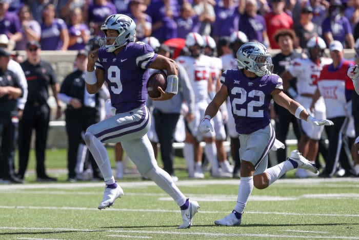 Oct 1, 2022; Manhattan, Kansas, USA; Kansas State Wildcats quarterback Adrian Martinez (9) runs past running back Deuce Vaughn (22) for a touchdown during the fourth quarter against the Texas Tech Red Raiders at Bill Snyder Family Football Stadium.