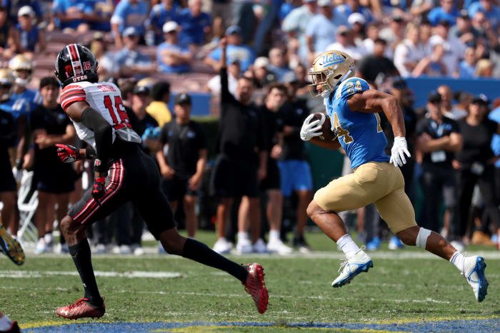 Oct 8, 2022; Pasadena, California, USA; UCLA Bruins running back Zach Charbonnet (24) runs with a ball against Utah Utes cornerback Zemaiah Vaughn (16) during the second quarter at Rose Bowl.