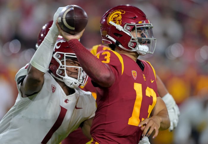 Oct 8, 2022; Los Angeles, California, USA; USC Trojans quarterback Caleb Williams (13) attempts a pass while Washington State Cougars linebacker Daiyan Henley (1) tackles him.