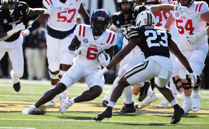 Oct 8, 2022; Nashville, Tennessee, USA; Mississippi Rebels running back Zach Evans (6) runs after a catch before being tackled by Vanderbilt Commodores defensive back Jaylen Mahoney (23) during the first half at FirstBank Stadium.