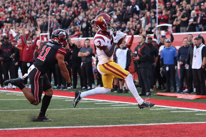 Oct 15, 2022; Salt Lake City, Utah, USA; USC Trojans wide receiver Jordan Addison (3) scores a touchdown against Utah Utes safety R.J. Hubert (11) in the first quarter at Rice-Eccles Stadium.
