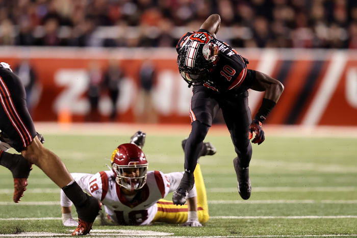 Oct 15, 2022; Salt Lake City, Utah, USA; USC Trojans linebacker Eric Gentry (18) trips up Utah Utes wide receiver Money Parks (10) in the second half at Rice-Eccles Stadium.