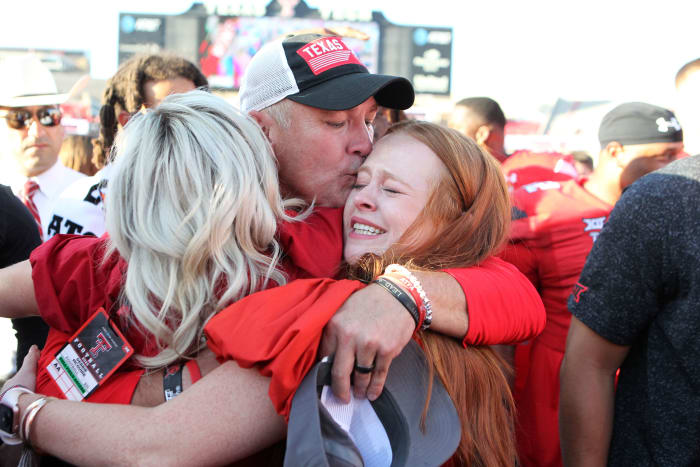 Sep 24, 2022; Lubbock, Texas, USA; Texas Tech Red Raiders head coach Joey McGuire kisses his daughter Raegan as he hugs his wife Debbie after the Red Raiders defeated the Texas Longhorns in overtime at Jones AT&T Stadium and Cody Campbell Field.