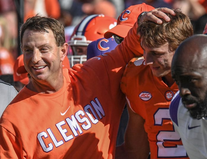 Oct 22, 2022; Clemson, South Carolina, USA; Clemson Tigers head coach Dabo Swinney and quarterback Cade Klubnik (2) celebrate in the closing seconds against the Syracuse Orange during the fourth quarter at Memorial Stadium.