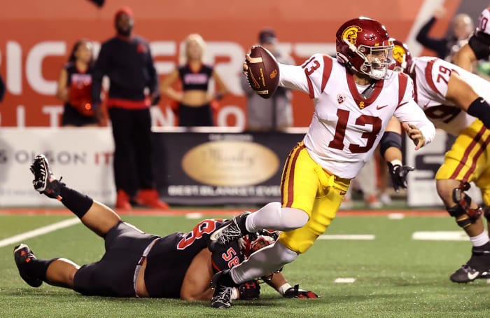 Oct 15, 2022; Salt Lake City, Utah, USA; USC Trojans quarterback Caleb Williams (13) breaks a tackle by Utah Utes defensive tackle Junior Tafuna (58) in the second quarter at Rice-Eccles Stadium. Mandatory Credit: Rob Gray-USA TODAY Sports