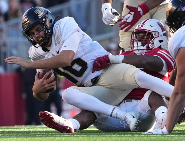 Oct 22, 2022; Madison, Wisconsin, USA; Wisconsin Badgers linebacker Jake Chaney (36) sacks Purdue Boilermakers quarterback Aidan O'Connell (16) during the third quarter at Camp Randall Stadium.