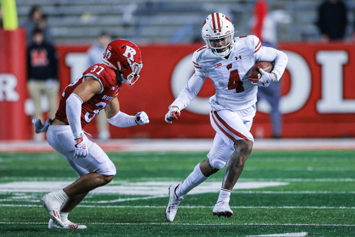 Nov 6, 2021; Piscataway, New Jersey, USA; Wisconsin Badgers wide receiver Markus Allen (4) gains yards after the catch as Rutgers Scarlet Knights defensive back Joe Lusardi (37) pursues during the second half at SHI Stadium.