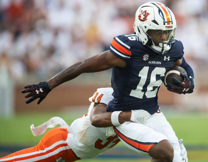 Auburn Tigers wide receiver Malcolm Johnson Jr. (16) is taken down by Mercer Bears safety Myles Redding (34) as Auburn Tigers take on Mercer Bears at Jordan-Hare Stadium in Auburn, Ala., on Saturday, Sept. 3, 2022.