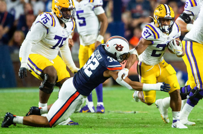 LSU Tigers running back Josh Williams (27) tries to elude Auburn Tigers linebacker Wesley Steiner (32) as the Auburn Tigers take on the LSU Tigers at Jordan-Hare Stadium in Auburn, Ala., on Saturday, Oct. 1, 2022.