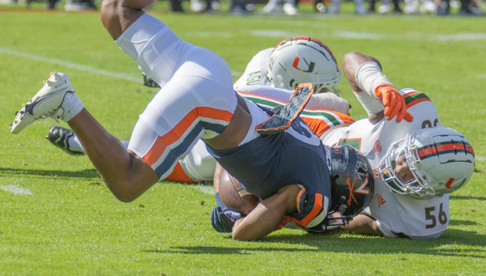 Oct 29, 2022; Charlottesville, Virginia, USA;Virginia Cavaliers running back Perris Jones (2) gets tackled by Miami Hurricanes defensive lineman Leonard Taylor (56) at Scott Stadium in the first half.
