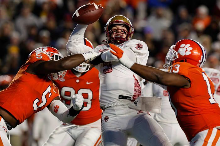 Oct 8, 2022; Chestnut Hill, Massachusetts, USA; Boston College Eagles quarterback Phil Jurkovec (5) is under pressure from Clemson Tigers defensive end K.J. Henry (5) and defensive tackle Tyler Davis (13) during the second half at Alumni Stadium. Mandatory Credit: Winslow Townson-USA TODAY Sports