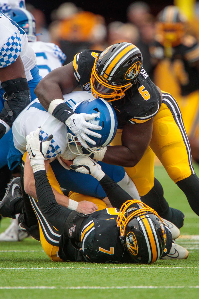 Nov 5, 2022; Columbia, Missouri, USA; Kentucky Wildcats quarterback Will Levis (7) is sacked by Missouri Tigers defensive lineman Darius Robinson (6) and Missouri Tigers defensive lineman DJ Coleman (7) during the second quarter at Faurot Field at Memorial Stadium.