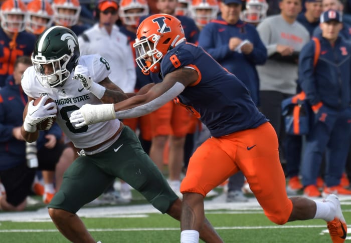 Nov 5, 2022; Champaign, Illinois, USA; Illinois Fighting Illini linebacker Tarique Barnes (8) tries to tackle Michigan State Spartans running back Jalen Berger (8) during the first half at Memorial Stadium.