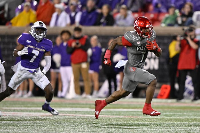 Nov 5, 2022; Louisville, Kentucky, USA; Louisville Cardinals running back Tiyon Evans (7) runs the ball to score a touch down against the James Madison Dukes during the second half at Cardinal Stadium. Louisville defeated James Madison 34-10
