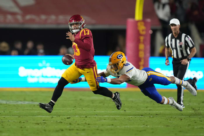 Nov 5, 2022; Los Angeles, California, USA; Southern California Trojans quarterback Caleb Williams (13) is pursued by California Golden Bears linebacker Orin Patu (48) in the first half at United Airlines Field at Los Angeles Memorial Coliseum.
