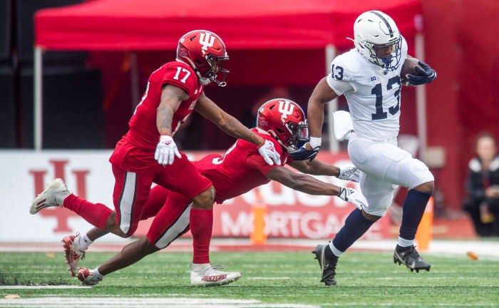 Penn State's Kaytron Allen (13) avoids Indiana's Tiawan Mullen (3) during the first half of the Indiana versus Penn State football game at Memorial Stadium on Satruday, Nov. 5, 2022.