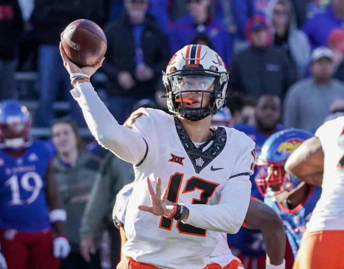 Nov 5, 2022; Lawrence, Kansas, USA; Oklahoma State Cowboys quarterback Garret Rangel (13) throws a pass against the Kansas Jayhawks during the second half of the game at David Booth Kansas Memorial Stadium.
