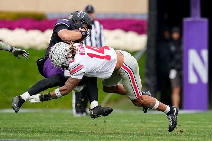 Nov 5, 2022; Evanston, Illinois, USA; Ohio State Buckeyes safety Ronnie Hickman (14) tackles Northwestern Wildcats quarterback Brendan Sullivan (10) during the second half of the NCAA football game at Ryan Field. Ohio State won 21-7.