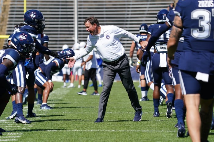 Sep 3, 2022; East Hartford, Connecticut, USA; Connecticut Huskies head coach Jim Mora greets his players as they warm up before the start of the game against the Central Connecticut State Blue Devils at Rentschler Field at Pratt & Whitney Stadium.