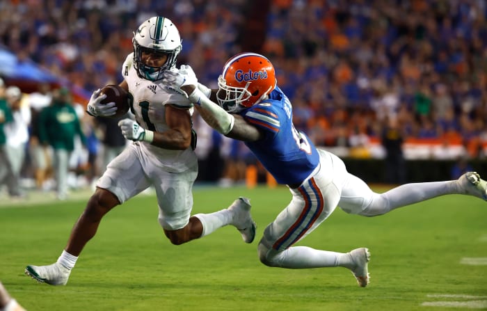 Sep 17, 2022; Gainesville, Florida, USA;Florida Gators safety Trey Dean III (0) tackles South Florida Bulls running back Brian Battie (21) during the second half at Ben Hill Griffin Stadium.