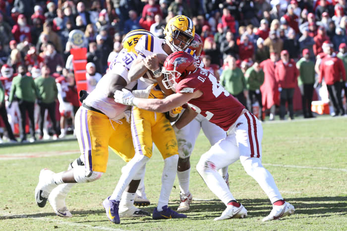 Arkansas linebacker Drew Sanders (42) tackles LSU quarterback Jayden Daniels in their matchup on Saturday, Nov. 12, 22, in Fayetteville, AR.