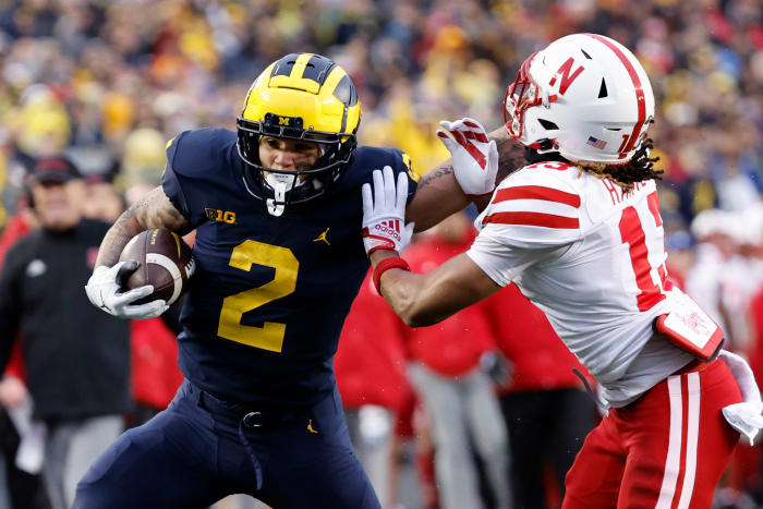 Nov 12, 2022; Ann Arbor, Michigan, USA; Michigan Wolverines running back Blake Corum (2) stiff arms Nebraska Cornhuskers defensive back Malcolm Hartzog (13) in the first half at Michigan Stadium.