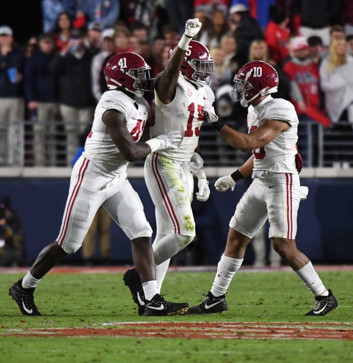 Nov 12, 2022; Oxford, Mississippi, USA; Alabama Crimson Tide linebacker Chris Braswell (41) and linebacker Dallas Turner (15) and linebacker Henry To'o To'o (10) celebrate after making a stop against the Ole Miss Rebels at Vaught-Hemingway Stadium. Alabama won 30-24.