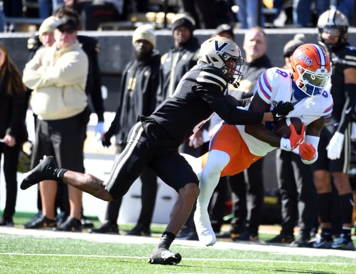 Nov 19, 2022; Nashville, Tennessee, USA; Florida Gators wide receiver Daejon Reynolds (8) completes a pass as he is defended by Vanderbilt Commodores cornerback Tyson Russell (8) during the first half at FirstBank Stadium.