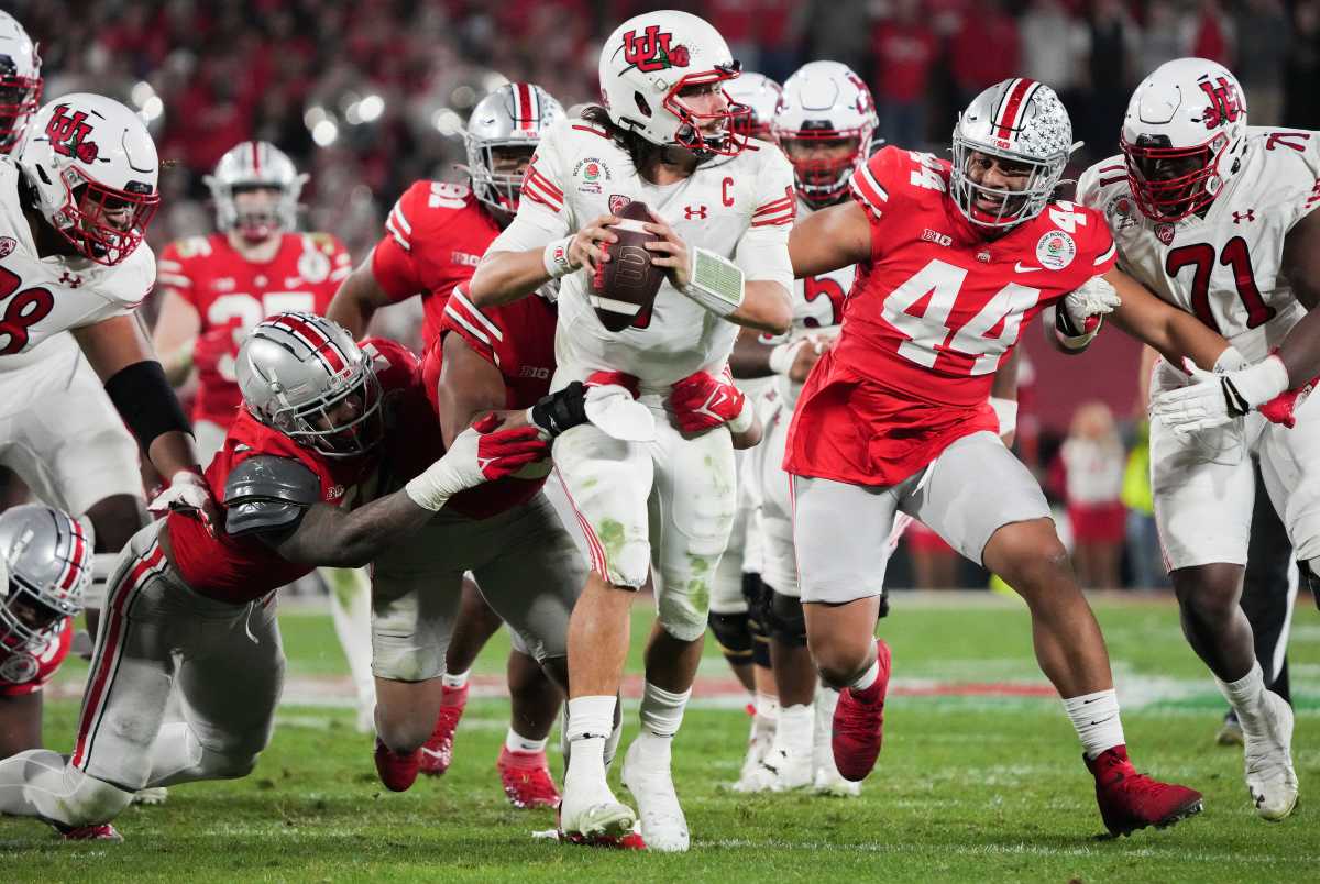 Sat., Jan. 1, 2022; Pasadena, California, USA; From left, Ohio State Buckeyes defenders Tyreke Smith (11), Kourt Williams II (2) and J.T. Tuimoloau (44) pressure and sack Utah Utes quarterback Cameron Rising (7) during the fourth quarter of the 108th Rose Bowl Game between the Ohio State Buckeyes and the Utah Utes