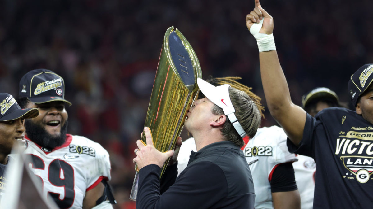 INDIANAPOLIS, INDIANA - JANUARY 10: Head Coach Kirby Smart of the Georgia Bulldogs celebrates with the National Championship trophy after the Georgia Bulldogs defeated the Alabama Crimson Tide 33-18 during the 2022 CFP National Championship Game at Lucas Oil Stadium on January 10, 2022 in Indianapolis, Indiana. (Photo by Carmen Mandato/Getty Images)