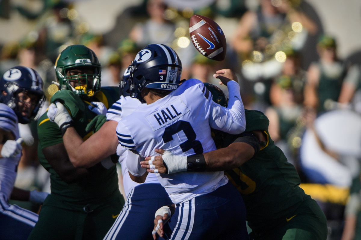 Oct 16, 2021; Waco, Texas, USA; Baylor Bears defensive lineman TJ Franklin (90) forces a fumble on Brigham Young Cougars quarterback Jaren Hall (3) during the second half at McLane Stadium. Mandatory Credit: Jerome Miron-USA TODAY Sports