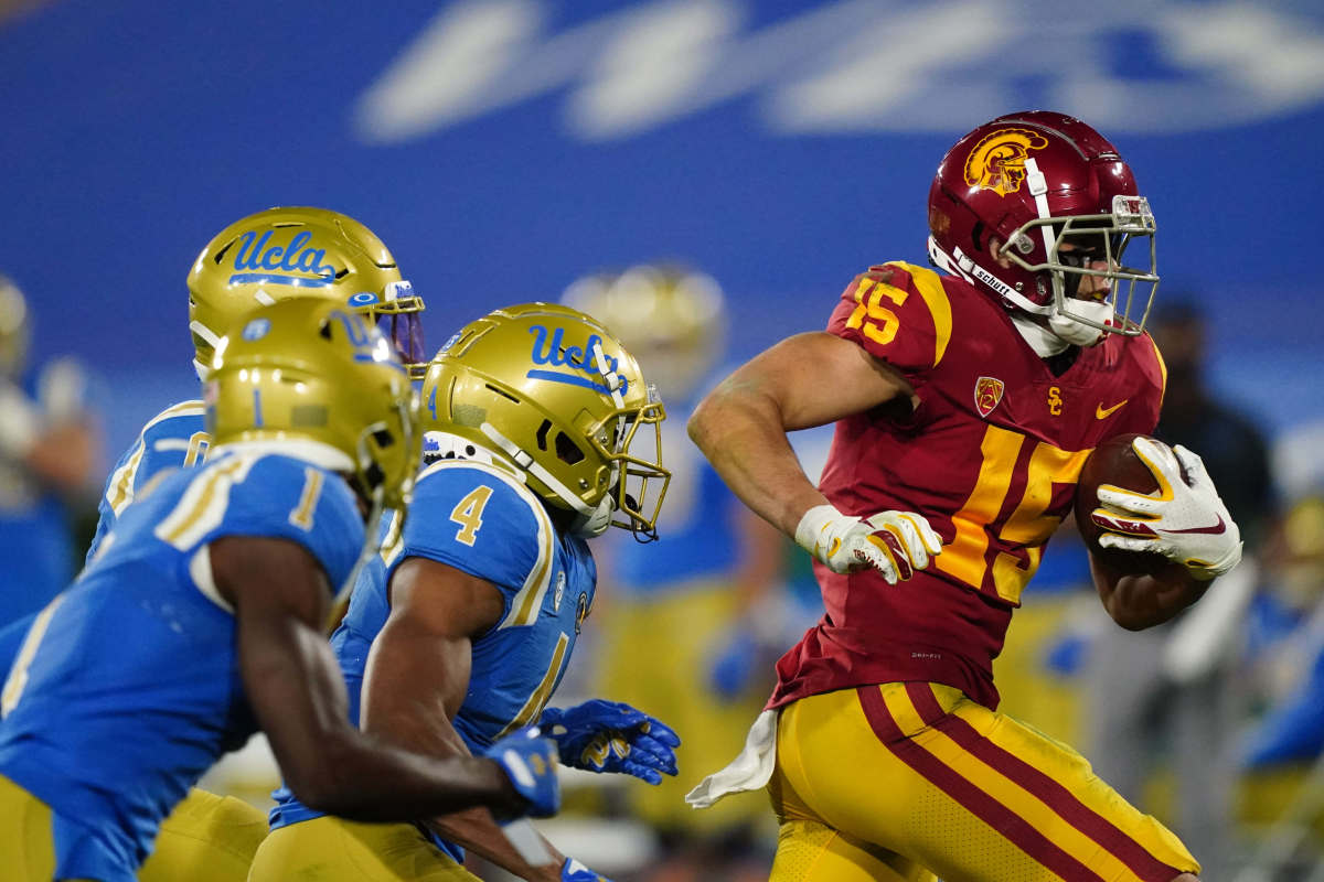 Dec 12, 2020; Pasadena, California, USA; Southern California Trojans wide receiver Drake London (15) is pursued by UCLA Bruins defensive back Stephan Blaylock (4) on a 65-yard touchdown reception in the second quarter at Rose Bowl. Mandatory Credit: Kirby Lee-USA TODAY Sports