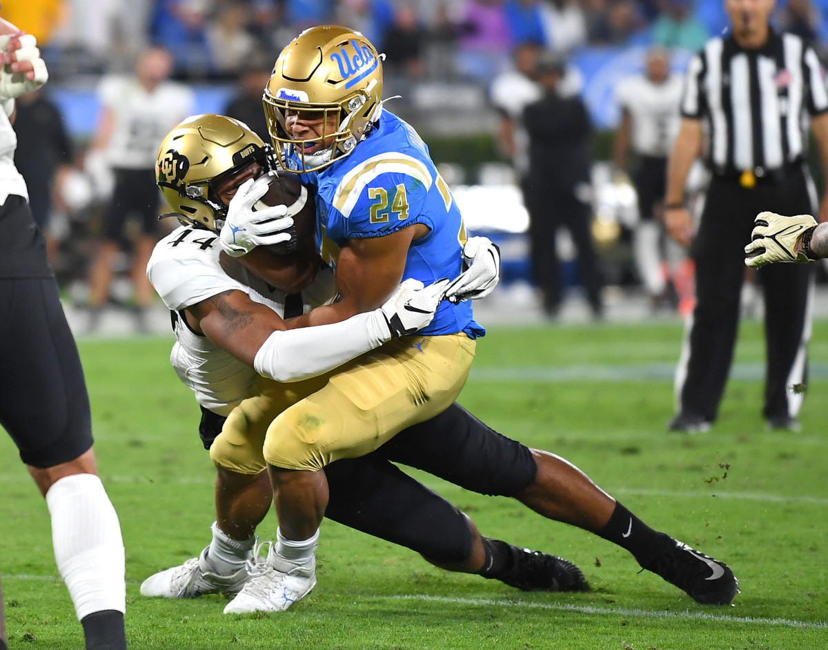 Nov 13, 2021; Pasadena, California, USA; UCLA Bruins running back Zach Charbonnet (24) is tackled by Colorado Buffaloes linebacker Devin Grant (44) in the second half at Rose Bowl.
