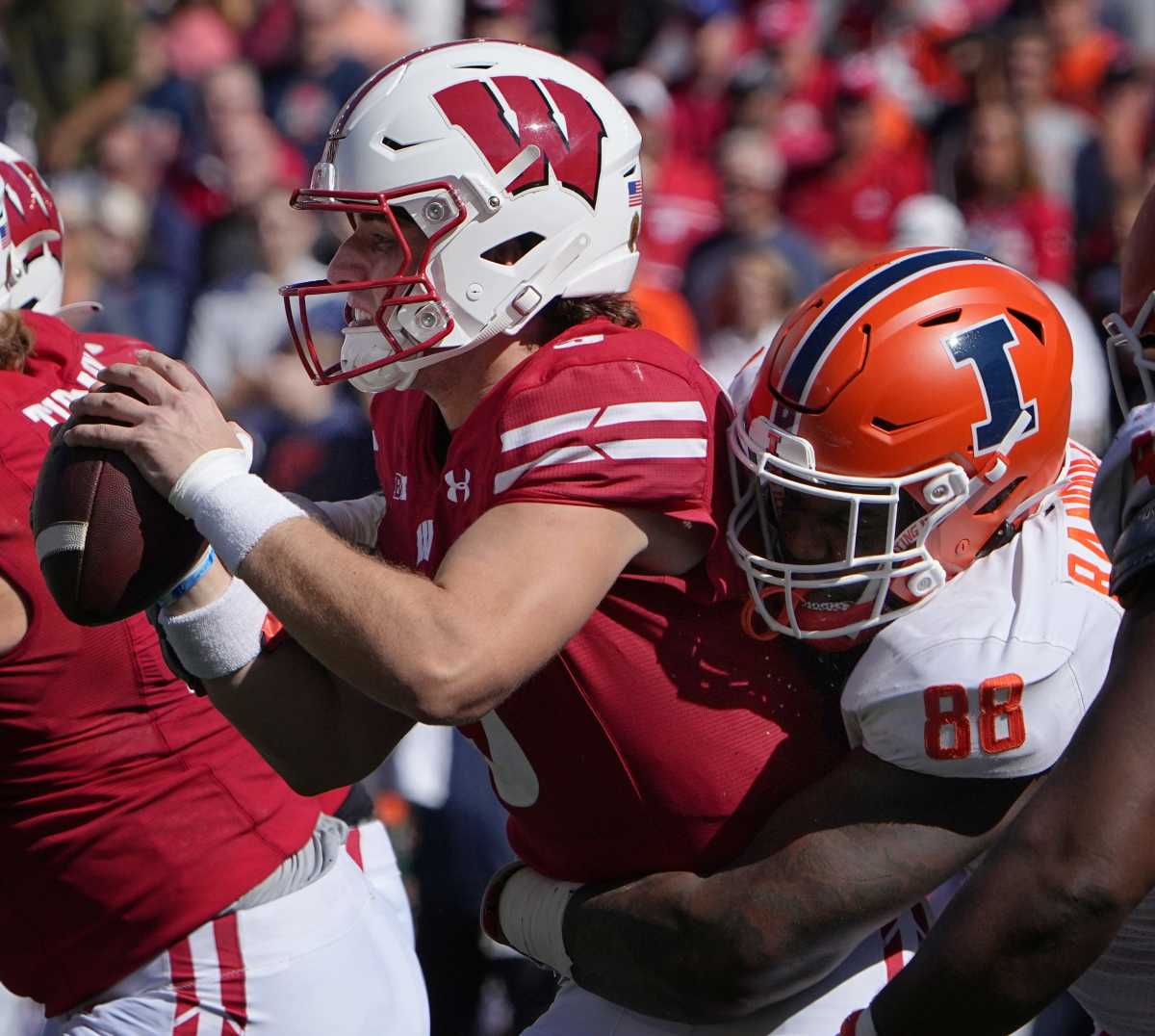 Wisconsin quarterback Graham Mertz (5) is sacked by Illinois defensive lineman Keith Randolph Jr. (88) during the fourth quarter of their game Saturday, October 1, 2022 at Camp Randall Stadium in Madison, Wis. Illinois beat Wisconsin 34-10.
