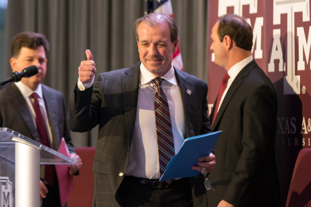 Dec 4, 2017; College Station, TX, USA; Texas A&M head coach Jimbo Fisher throws up a "gig 'em" as he walks on stage for the press conference held Monday morning at the Hall of Champions in Kyle Field