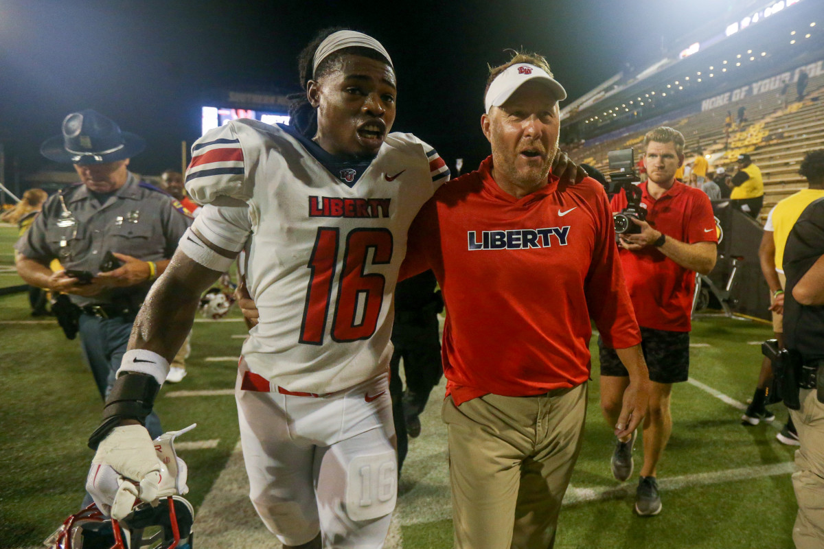 Sep 3, 2022; Hattiesburg, Mississippi, USA; Liberty Flames safety Quinton Reese (16) walks off the field with Liberty Flames head coach Hugh Freeze after win over the Southern Miss Golden Eagles at M.M. Roberts Stadium. Liberty won in overtime, 29-27. Mandatory Credit: Chuck Cook-USA TODAY Sports
