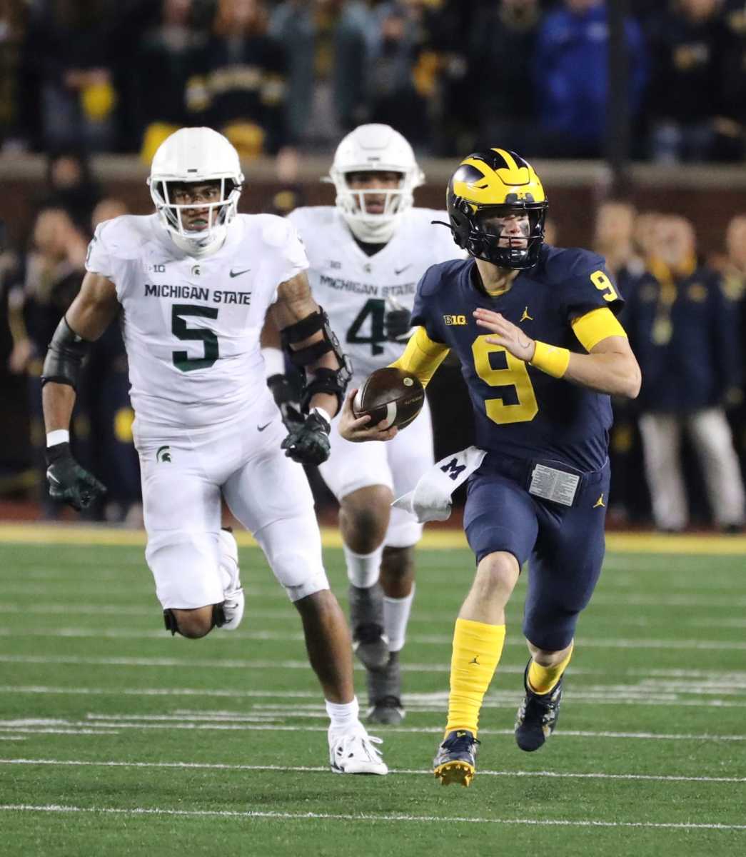 Michigan QB JJ McCarthy is seen here scrambling for a first down against Michigan State. Photo by Kirthmon F. Dozier of the Detroit Free Press