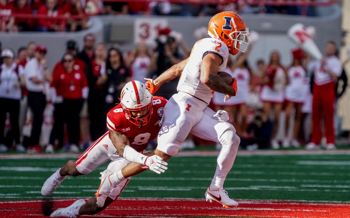 Illinois RB Chase Brown (2) breaks through a tackle in a matchup against Nebraska.