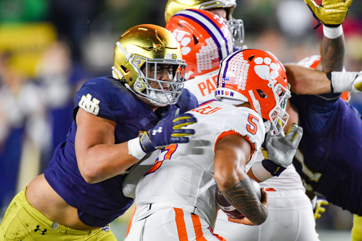 Nov 5, 2022; South Bend, Indiana, USA; Clemson Tigers quarterback DJ Uiagalelei (5) is sacked by Notre Dame Fighting Irish defensive lineman Howard Cross III (56) in the second quarter at Notre Dame Stadium. Mandatory Credit: Matt Cashore-USA TODAY Sports