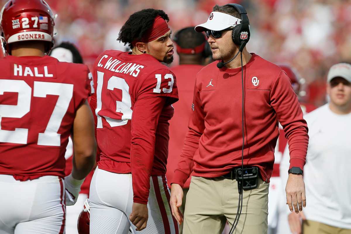 Coach Lincoln Riley talks with Caleb Williams (13) during the Sooners' 28-21 win against Iowa State on Nov. 20, 2021. Both now are reunited at USC.