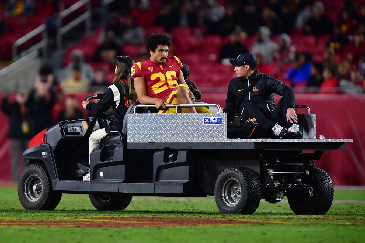 Nov 11, 2022; Los Angeles, California, USA; Southern California Trojans running back Travis Dye (26) is taken off the field after suffering an apparent injury against the Colorado Buffaloes during the first half at the Los Angeles Memorial Coliseum.