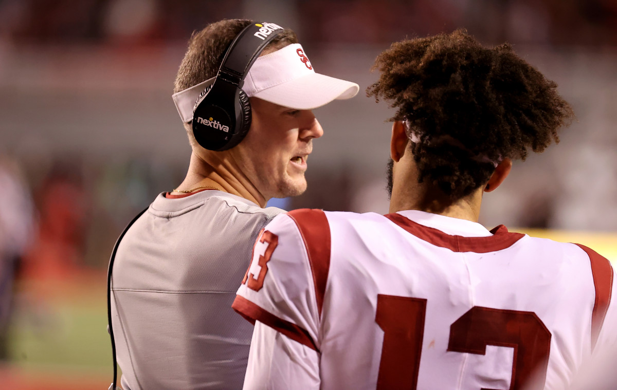 Oct 15, 2022; Salt Lake City, Utah, USA; USC Trojans head coach Lincoln Riley speaks with quarterback Caleb Williams (13) during a time out against the Utah Utes in the second quarter at Rice-Eccles Stadium. Mandatory Credit: Rob Gray-USA TODAY Sports