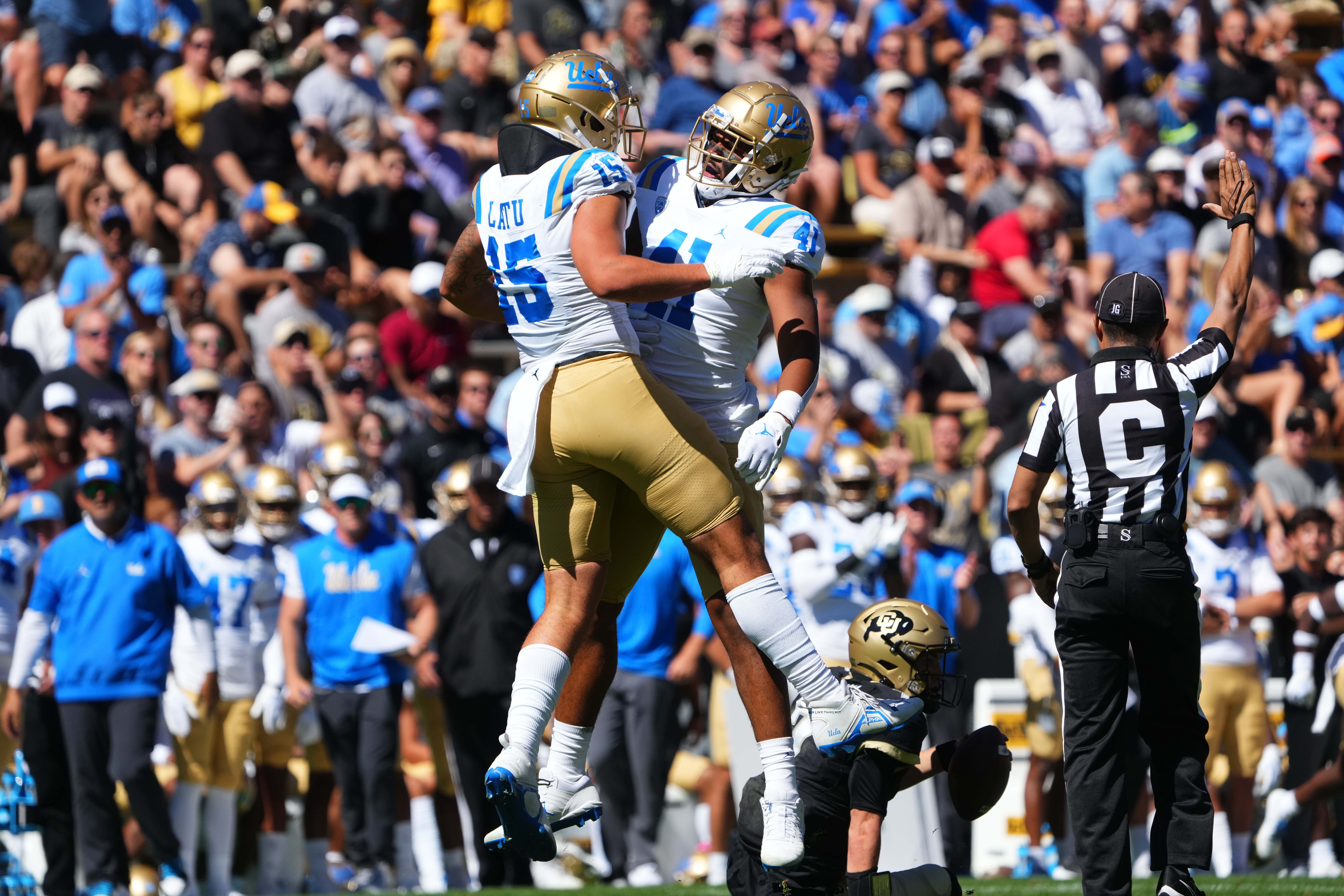 Sep 24, 2022; Boulder, Colorado, USA; UCLA Bruins linebacker Laiatu Latu (15) and linebacker Devin Aupiu (41) celebrate a play in the first quarter against the Colorado Buffaloes at Folsom Field.