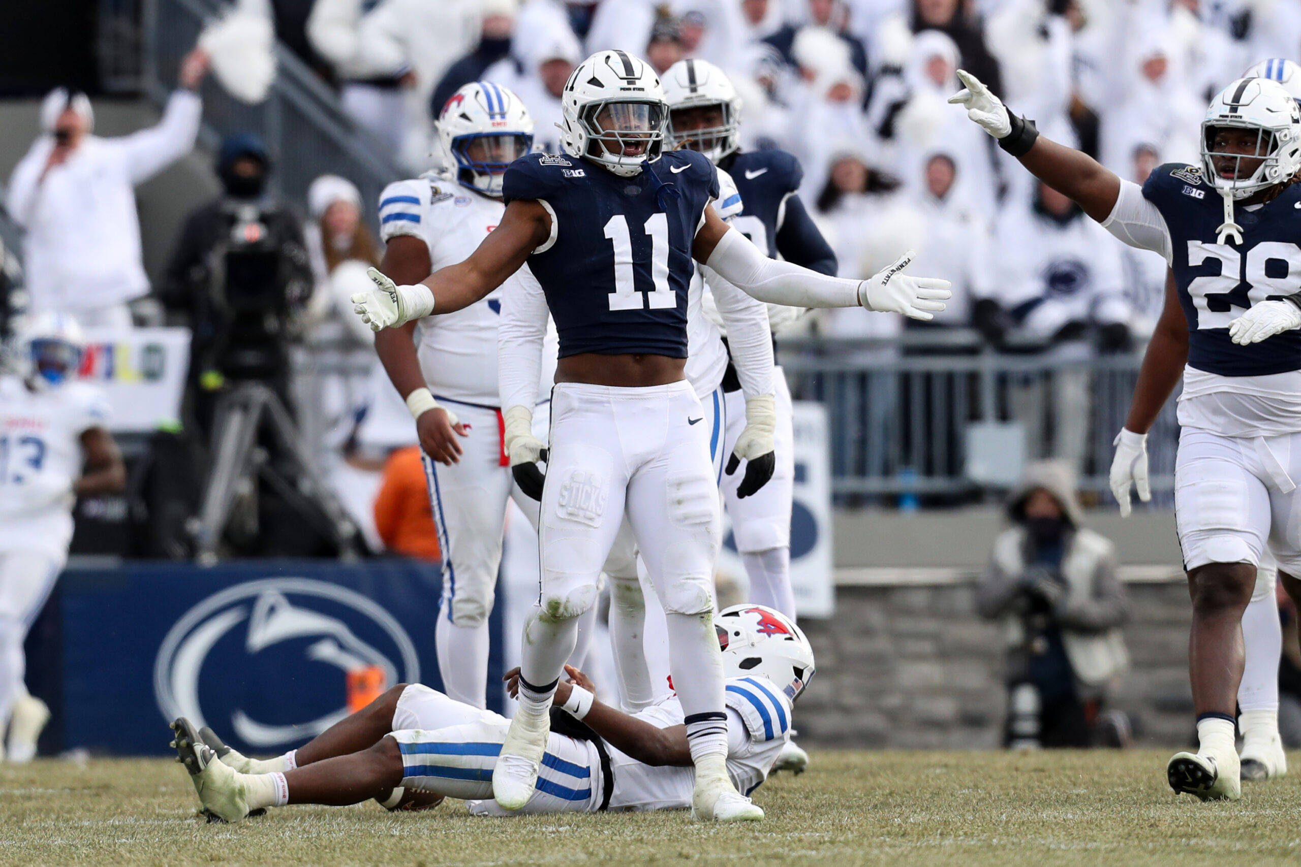 Dec 21, 2024; University Park, Pennsylvania, USA; Penn State Nittany Lions defensive end Abdul Carter (11) reacts after sacking Southern Methodist Mustangs quarterback Kevin Jennings (7) during the third quarter in the first round of the College Football Playoff at Beaver Stadium. 