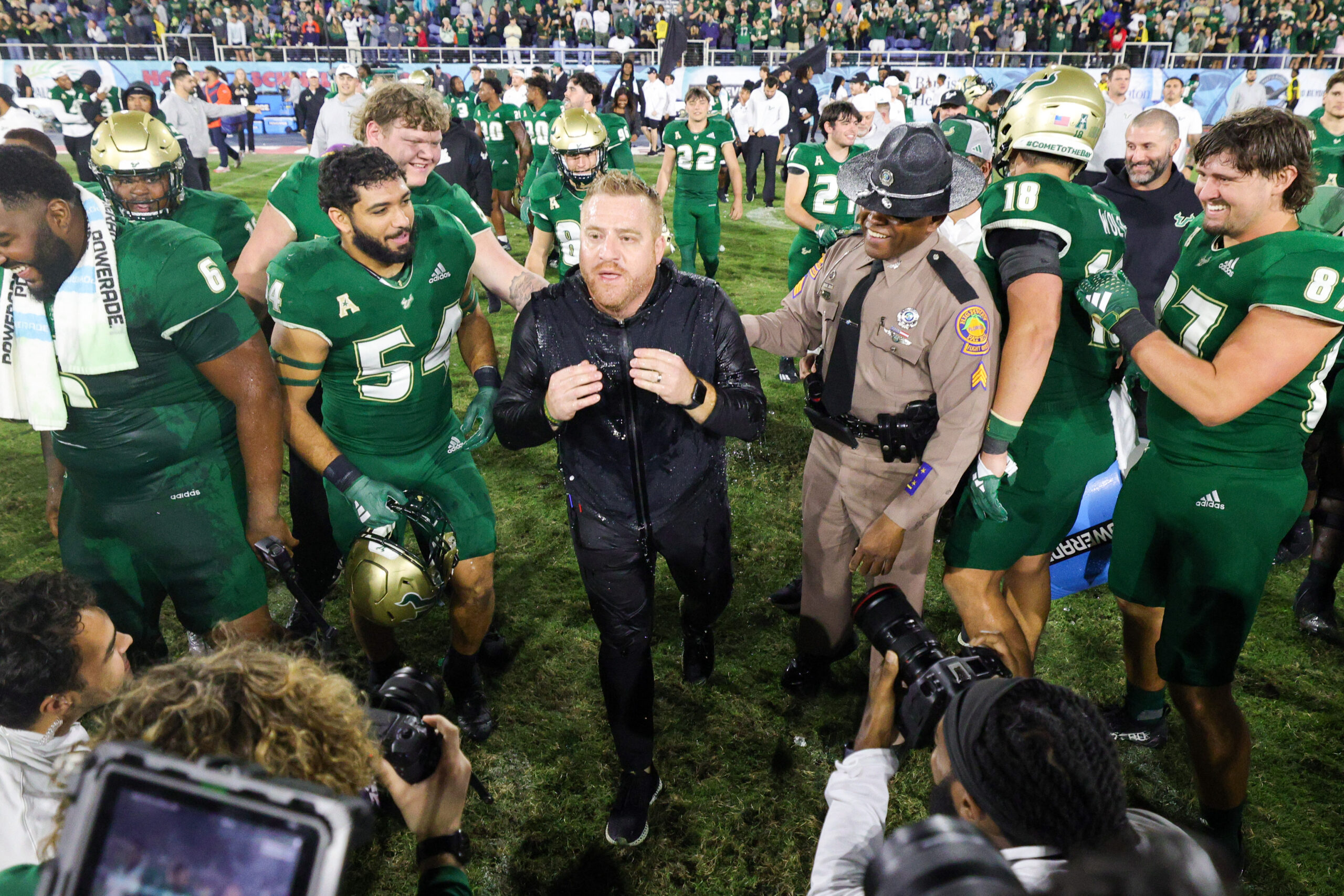 Dec 21, 2023; Boca Raton, FL, USA; South Florida Bulls head coach Alex Golesh is congratulated after beating the Syracuse Orange in the RoofClaim.com Boca Raton Bowl at FAU Stadium.
