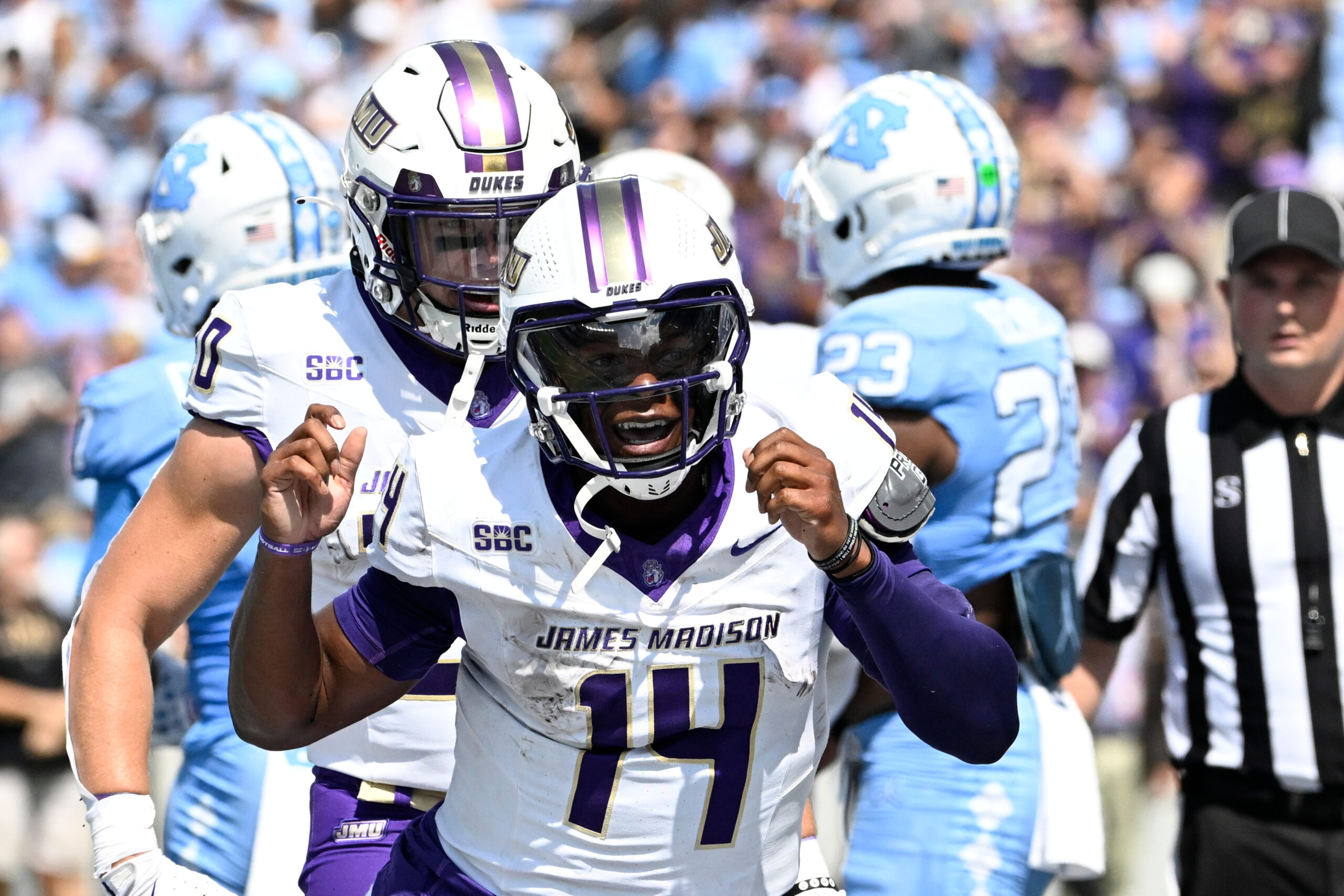 Sep 21, 2024; Chapel Hill, North Carolina, USA; James Madison Dukes quarterback Alonza Barnett III (14) celebrates after scoring atouchdown in the first quarter at Kenan Memorial Stadium.